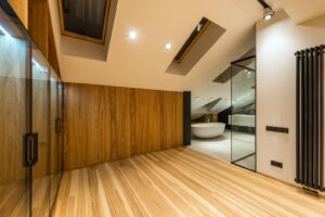 Modern wooden bathroom with freestanding tub and skylights