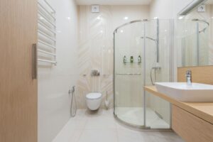 Contemporary bathroom with curved glass shower and vessel sink
