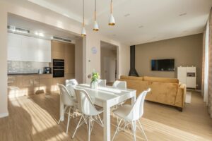 Open plan dining and living room with yellow sofa
