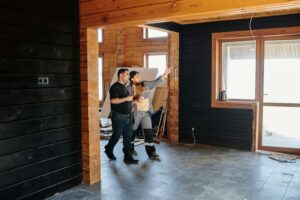 Couple with contractor in unfinished home